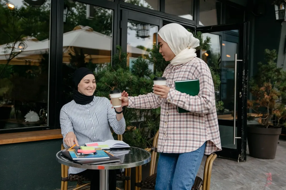 A coffee handoff between friends